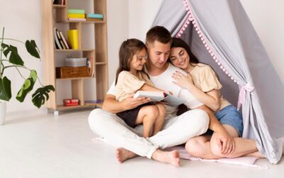 Family enjoying quality time together in a cozy indoor setting, reading a book in a play tent, emphasizing home comfort and family bonding.