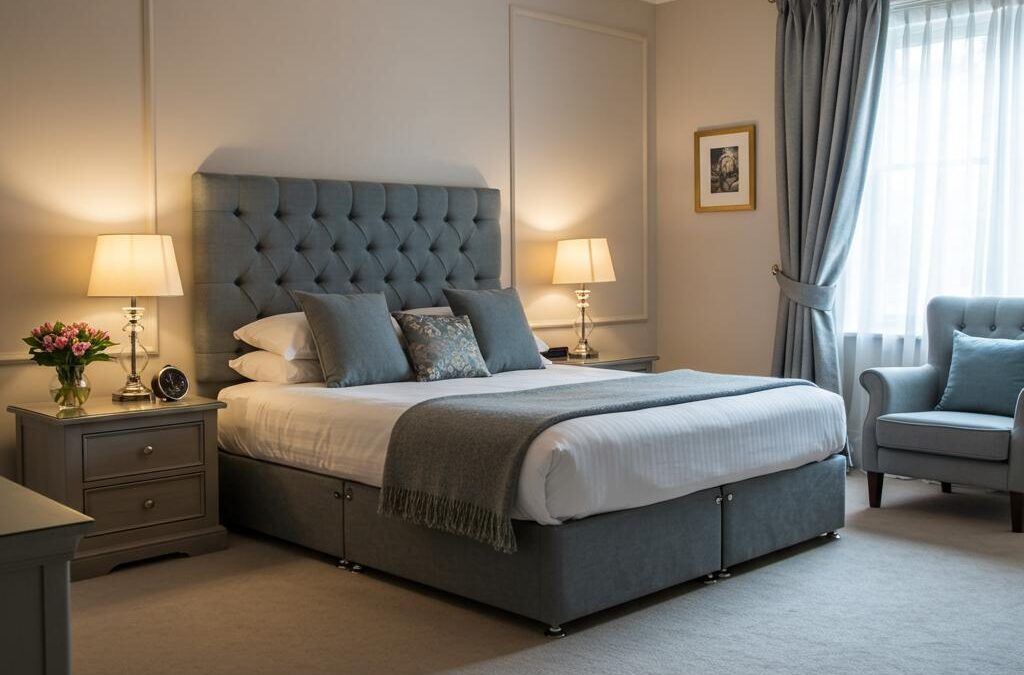 Elegant bedroom featuring a neatly made bed with a gray upholstered headboard, decorative pillows, bedside lamps, and a cozy armchair, emphasizing the importance of a clean and inviting sleeping environment.